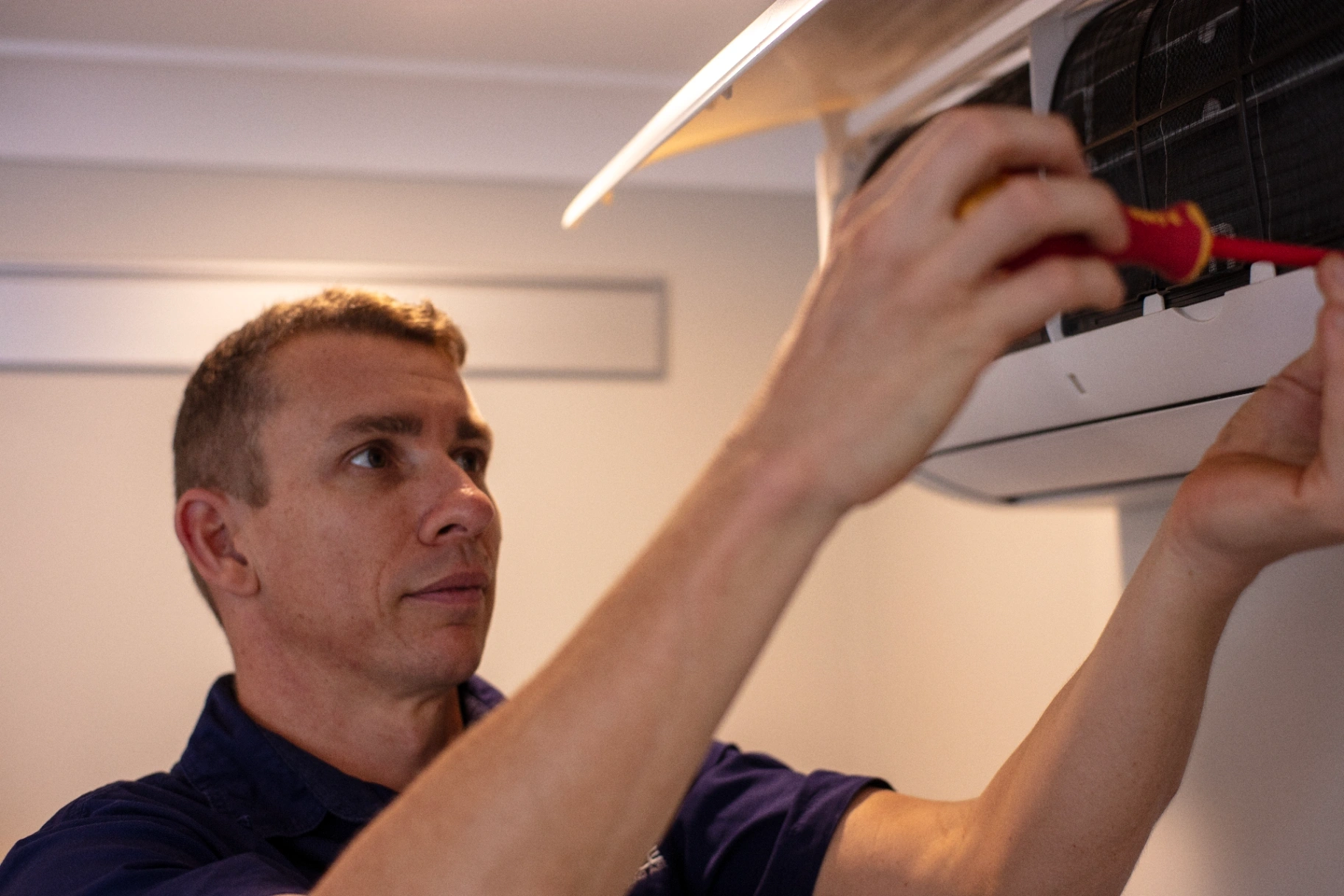 Technician installing a Daikin air conditioning system
