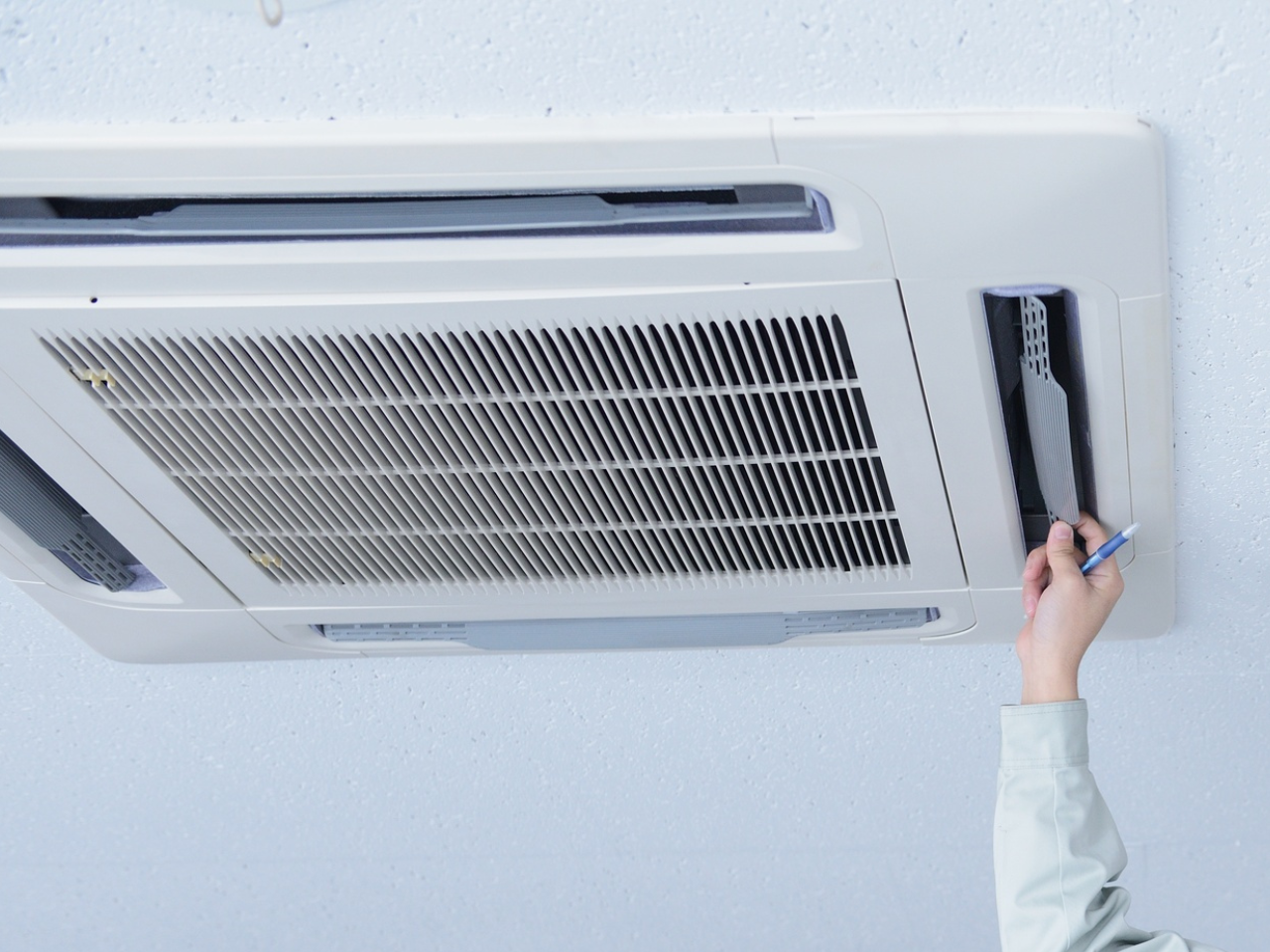 Ducted air conditioning ductwork being inspected for damage and leaks