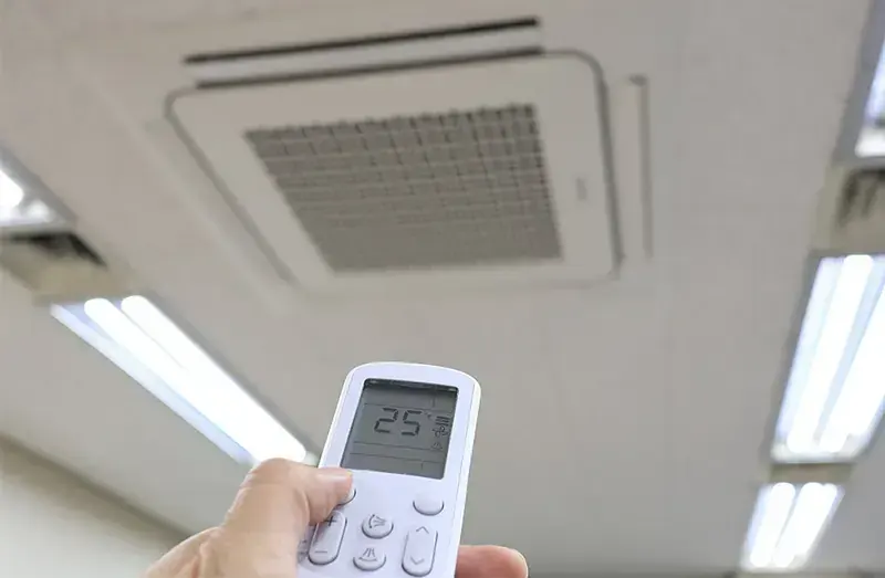 Ducted air conditioning technician carrying out a repair