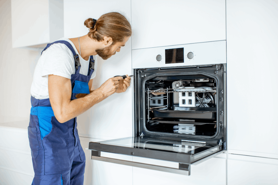 Electrician installing a new electric oven in a Brisbane kitchen