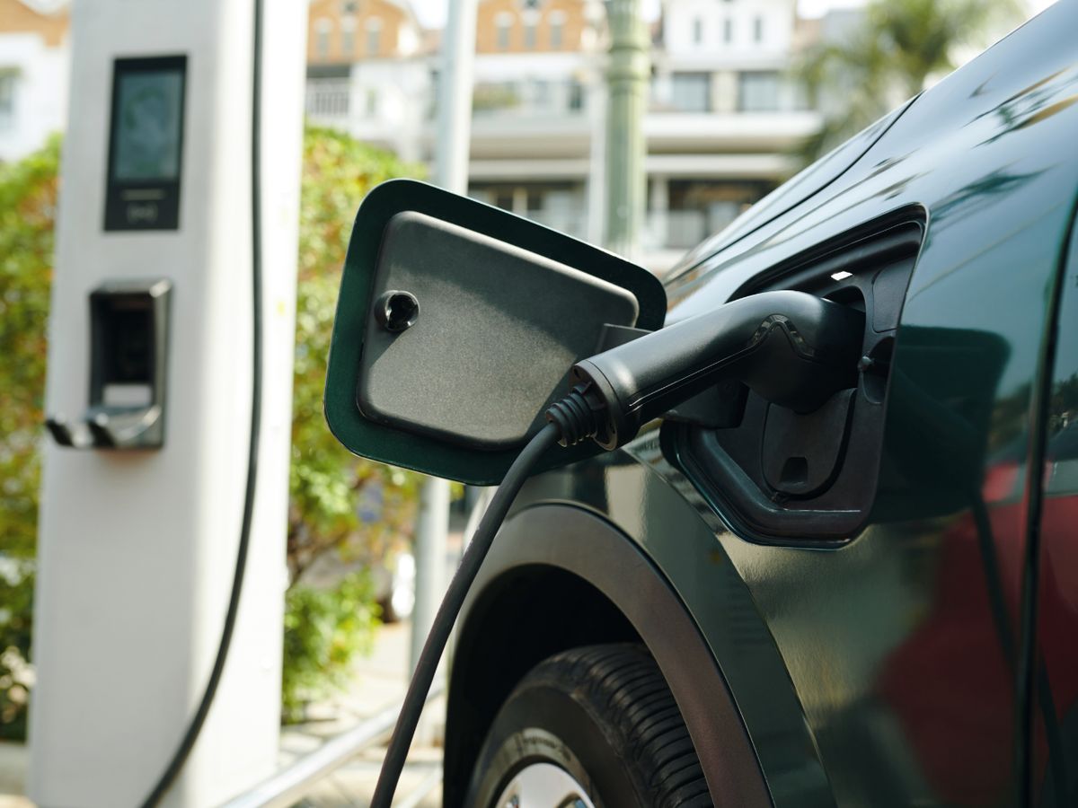Electric vehicle charging cable connected to a car